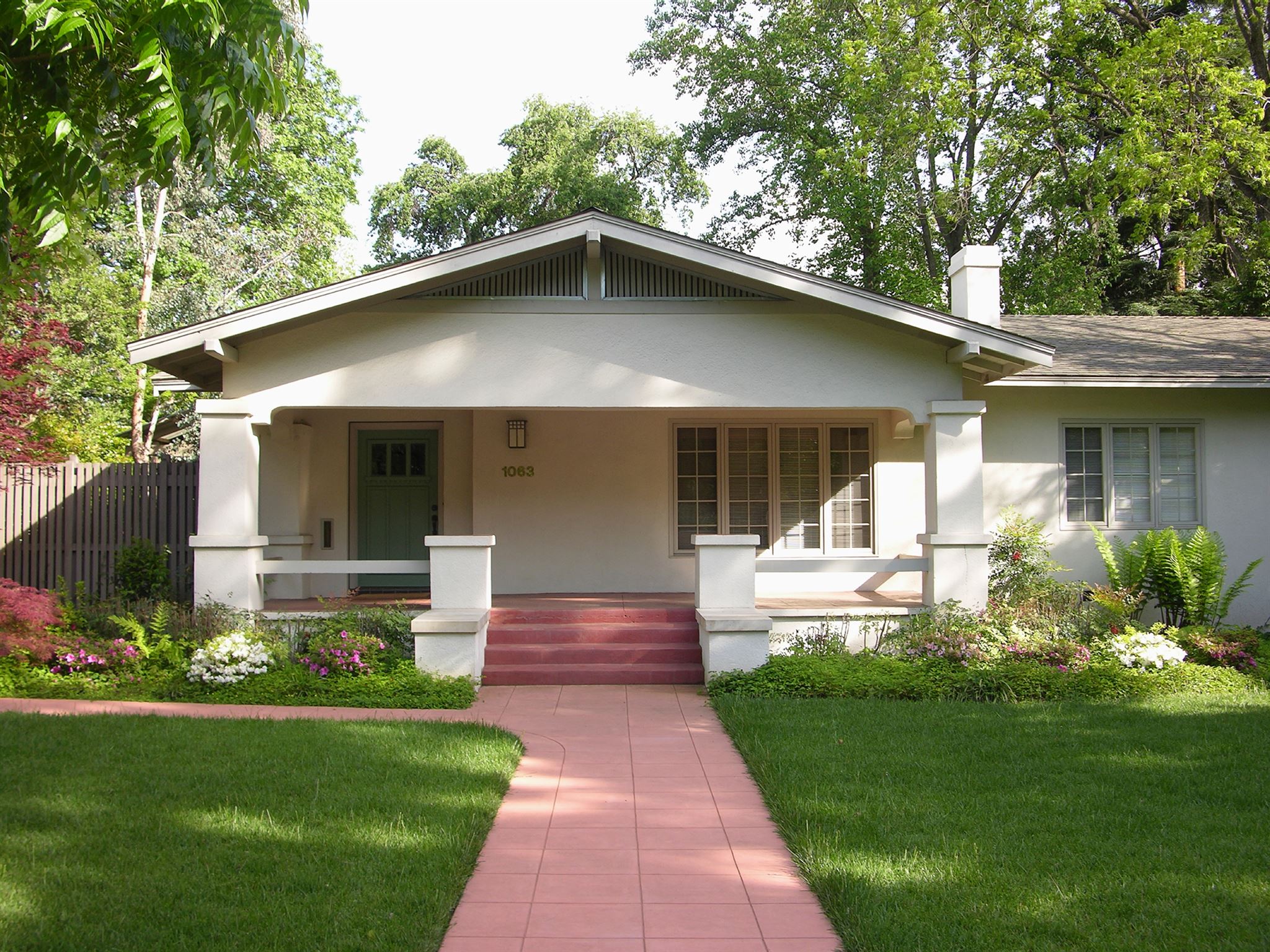 Pink-cemented-pathway-leading-to-house-with-porch